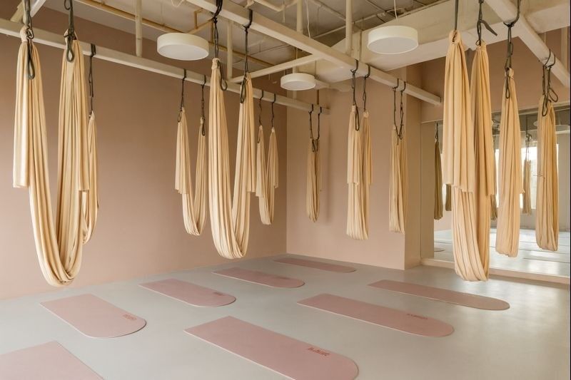 Private gym space with aerial yoga hammocks, offering specialized and customized fitness sessions