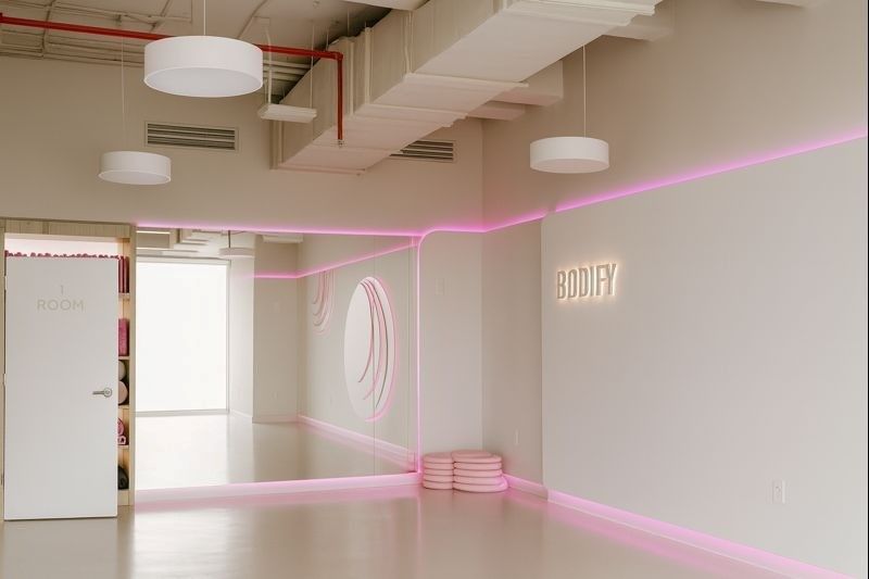 Clean and stylish private gym studio with soft lighting, designed for personalized training sessions
