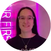 Photo of Valeria, a BODIFY client, wearing glasses in front of neon studio lighting