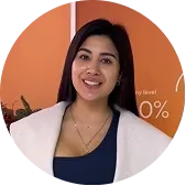 Photo of Maria, a BODIFY client, smiling in front of an orange backdrop