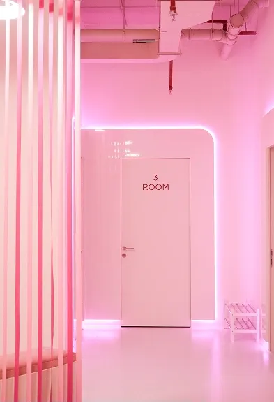 Pink-lit hallway inside the BODIFY studio