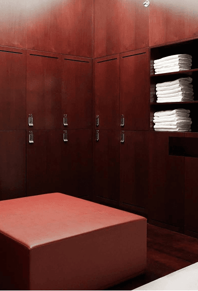 Wooden lockers with neatly folded towels in the changing area of a women-only fitness studio in Downtown Dubai