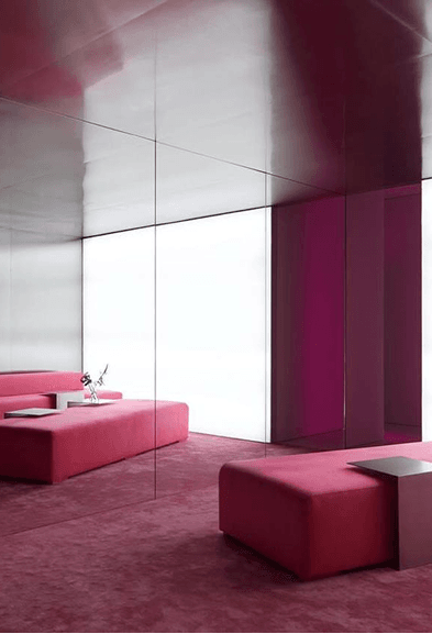 Pink lounge area with mirrored walls inside a women-only fitness studio 