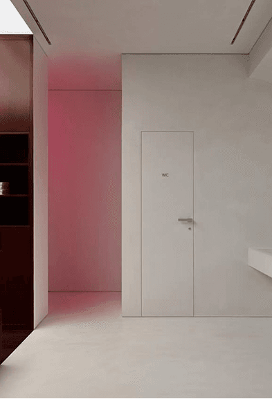Minimal white hallway with restroom entrance in the clean, modern interior
