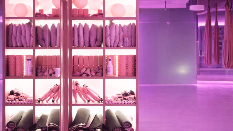 Modern stretching studio with organized equipment and soft lighting, designed for assisted stretching sessions