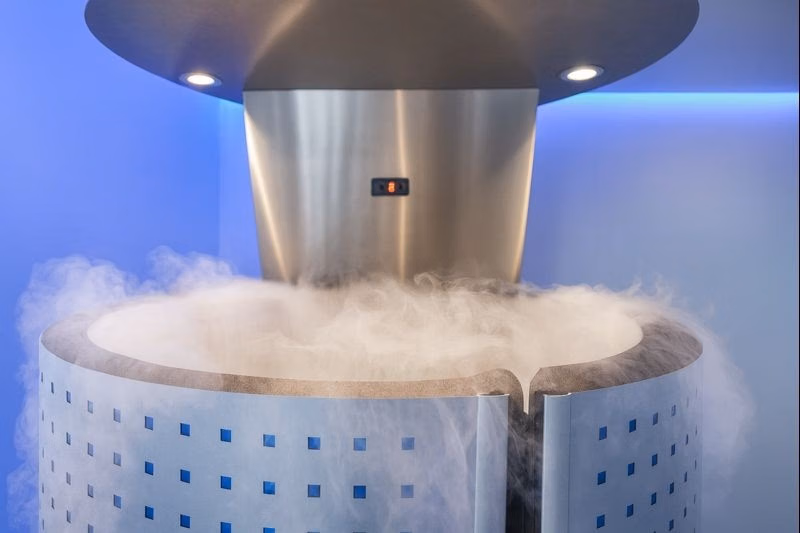 Cryotherapy chamber filled with cold vapor, used for muscle recovery and wellness treatments