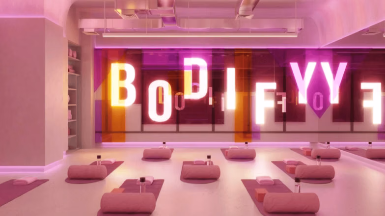 Modern fitness studio with neon lighting and workout mats, designed for high energy calorie burning classes in Dubai