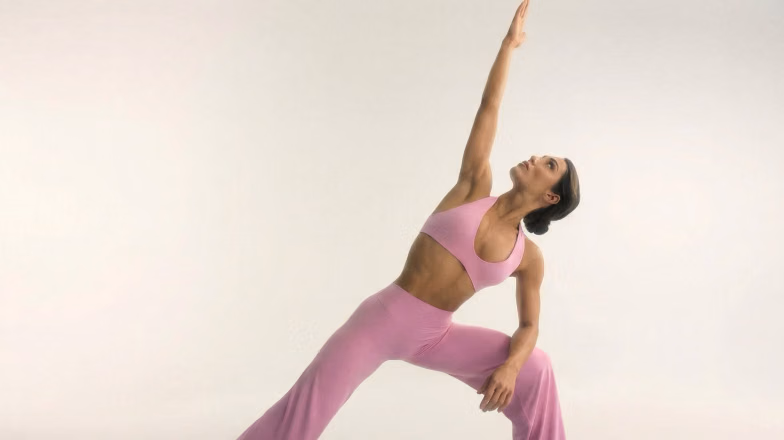 Woman performing a strength and flexibility exercise, supporting muscle growth and recovery during training